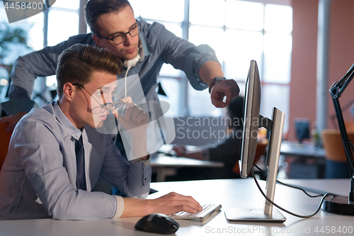 Image of Two Business People Working With computer in office