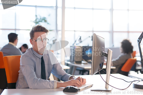 Image of businessman working using a computer in startup office