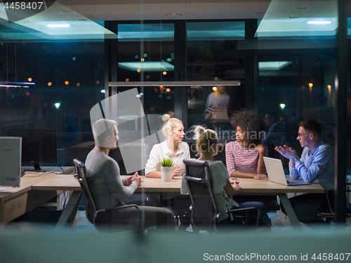 Image of Multiethnic startup business team in night office