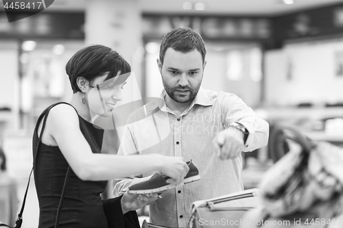 Image of couple chooses shoes At Shoe Store