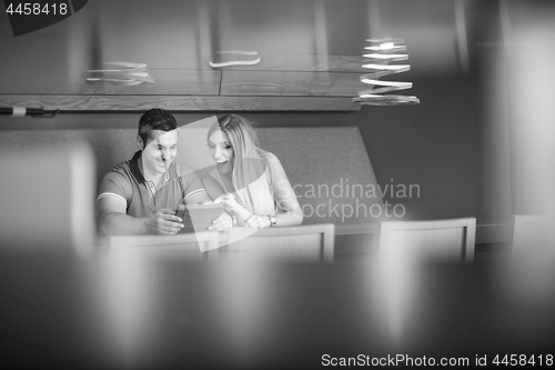 Image of couple using tablet at home