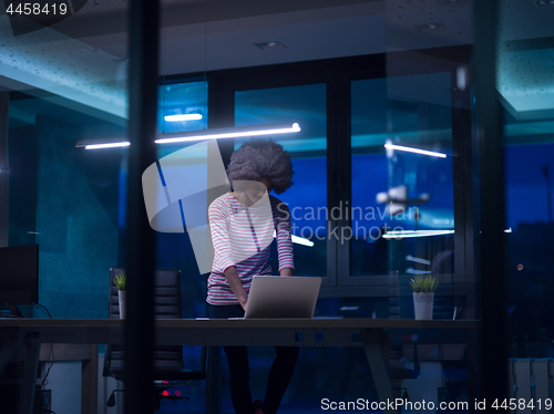 Image of black businesswoman using a laptop in startup office