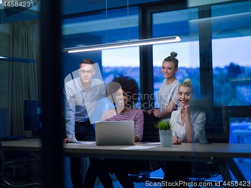 Image of Multiethnic startup business team in night office