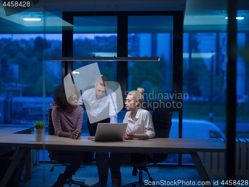 Image of Multiethnic startup business team in night office