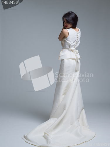 Image of Rear view of a beautiful young woman in a wedding dress