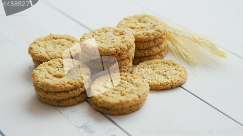 Image of Healthy oatmeal cookies on white wood background, Side view.
