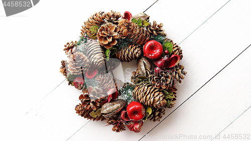 Image of Christmas Wreath on White Wooden Background