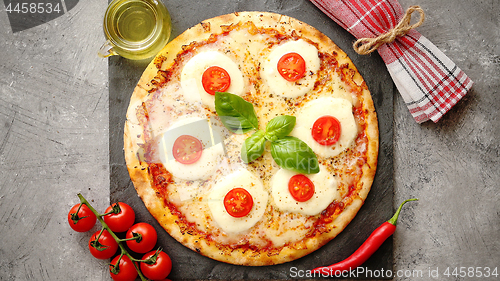 Image of Homemade pizza with tomatoes, mozzarella