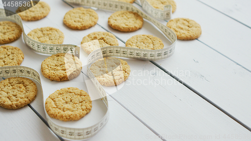 Image of Healthy oatmeal cookies on white wood background, side view.