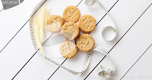 Image of Healthy oatmeal cookies on white wood background, top view.
