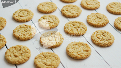 Image of Healthy oatmeal cookies on white wood background, Side view.