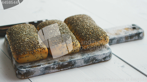 Image of Closeup of whole grain bread with seeds on a rustic wooden board