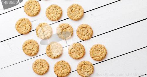 Image of Healthy oatmeal cookies on white wood background, top view.