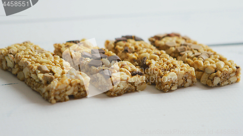 Image of Granola bars with dried fruits wooden background