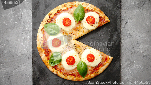 Image of Homemade pizza with tomatoes, mozzarella