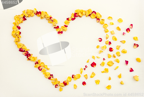 Image of Floral heart with rose petals flying away