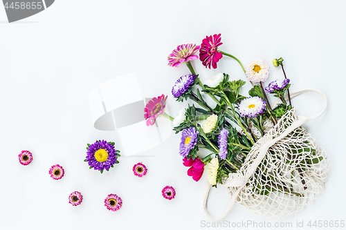 Image of Bouquet of asters and dahlias in a mesh bag