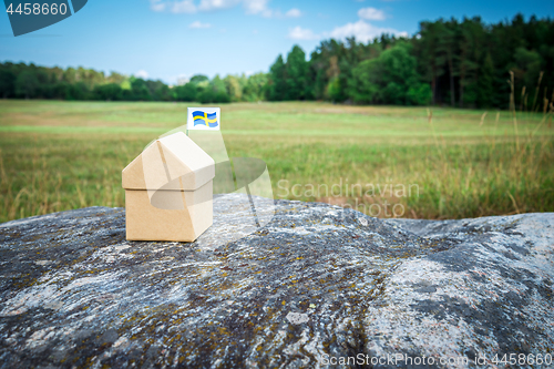 Image of Little cardboard house in Swedish summer landscape