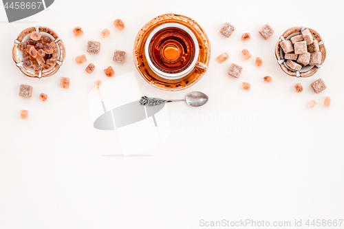 Image of Cup of tea and pieces of brown sugar