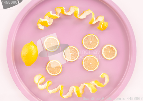 Image of Lemons and spiral peel on a pink tray