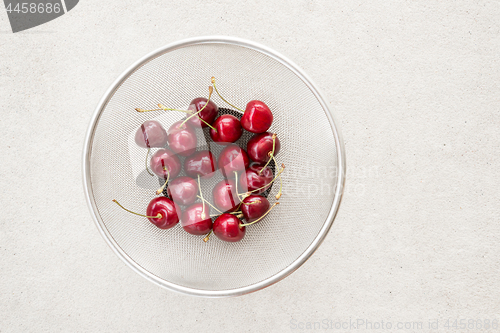 Image of Fresh cherries in a round colander