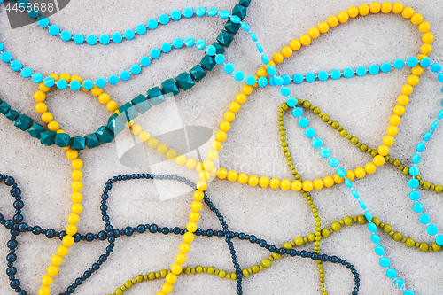 Image of Colorful necklaces on concrete background