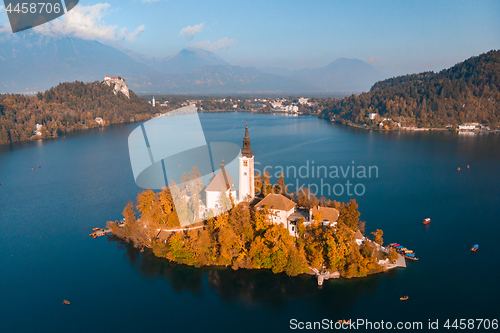 Image of Aerial view of Bled island on lake Bled, and Bled castle and mountains in background, Slovenia.