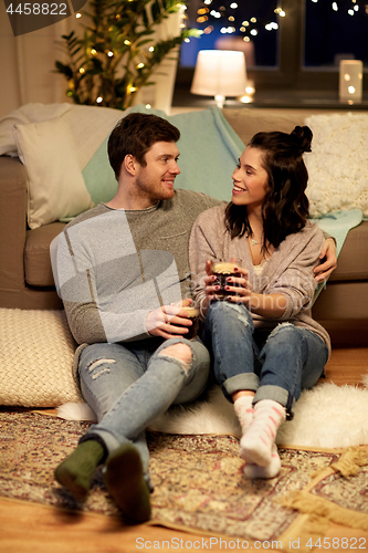 Image of happy couple drinking coffee and eating at home
