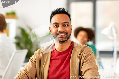 Image of smiling indian man at office