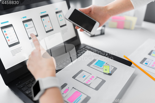 Image of web designers work on smartphone user interface