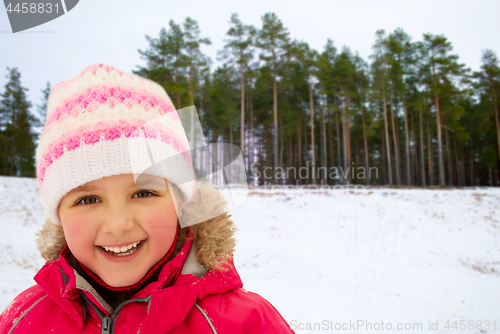 Image of happy little girl in winter clothes outdoors