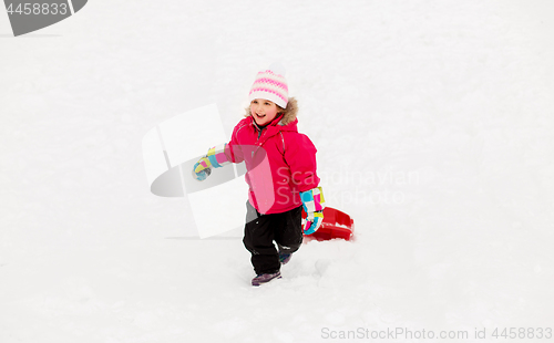 Image of little girl with sled on snow hill in winter