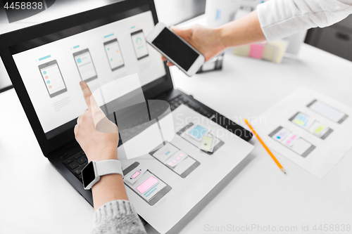 Image of web designers work on smartphone user interface