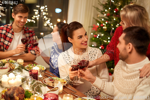 Image of friends celebrating christmas and drinking wine