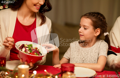 Image of happy family having christmas dinner at home
