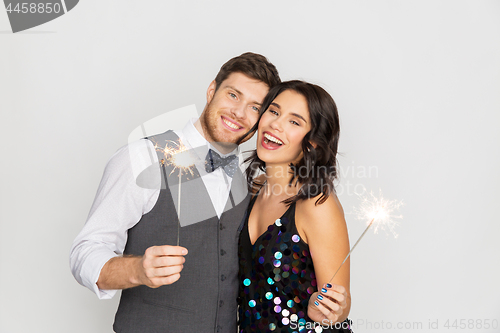 Image of happy couple with sparklers at party