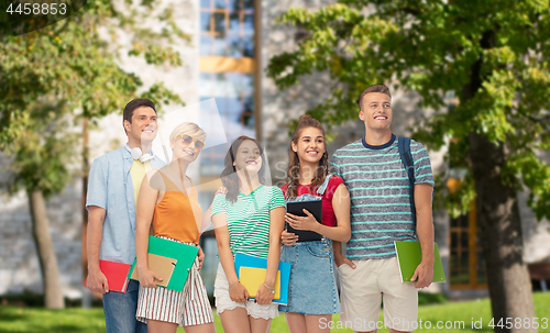 Image of students with books and folders over campus