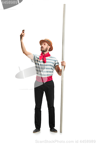 Image of Caucasian man in traditional gondolier costume and hat