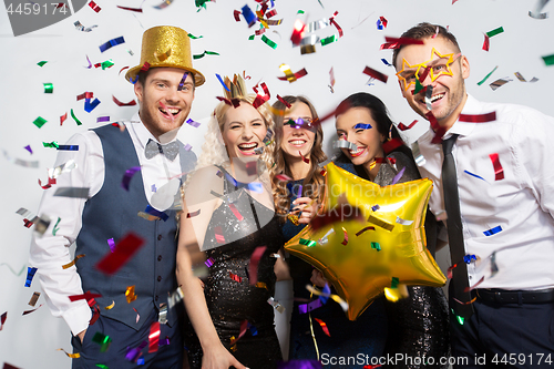 Image of friends with party props and confetti laughing