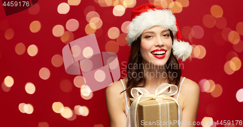 Image of woman in santa hat with christmas gift