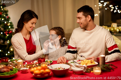 Image of happy family having christmas dinner at home