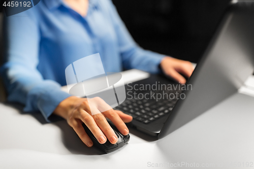 Image of close up of female hand using computer mouse