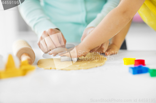 Image of mother and daughter making cookies at home