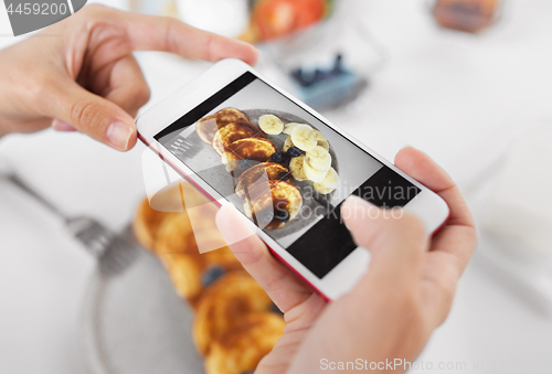 Image of hands with smartphones photographing food