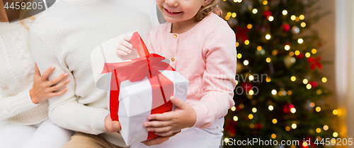 Image of close up of happy family with christmas gift