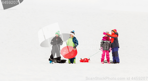 Image of happy little kids with sleds in winter