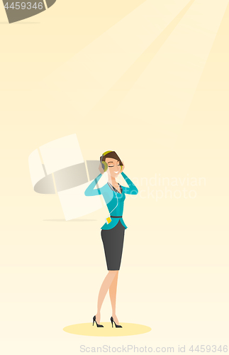 Image of Young woman in headphones listening to music.