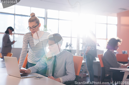 Image of Two Business People Working With laptop in office