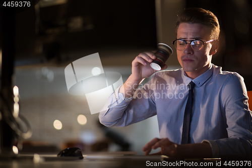 Image of Tired businessman working late