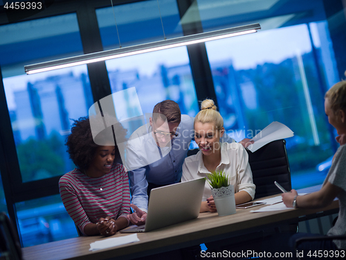 Image of Multiethnic startup business team in night office